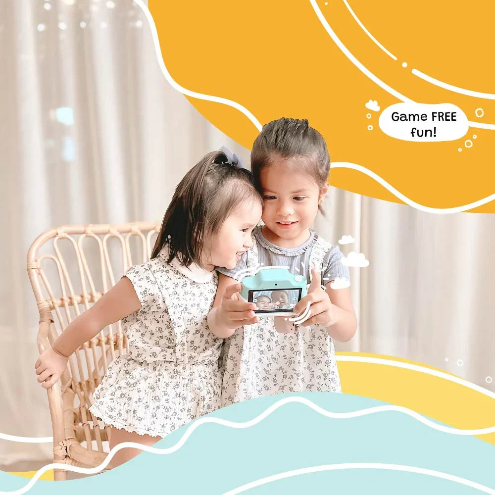Two young girls playing with kiimento Model K Zippy the Sloth kids digital camera indoors, enjoying screen preview for game-free fun