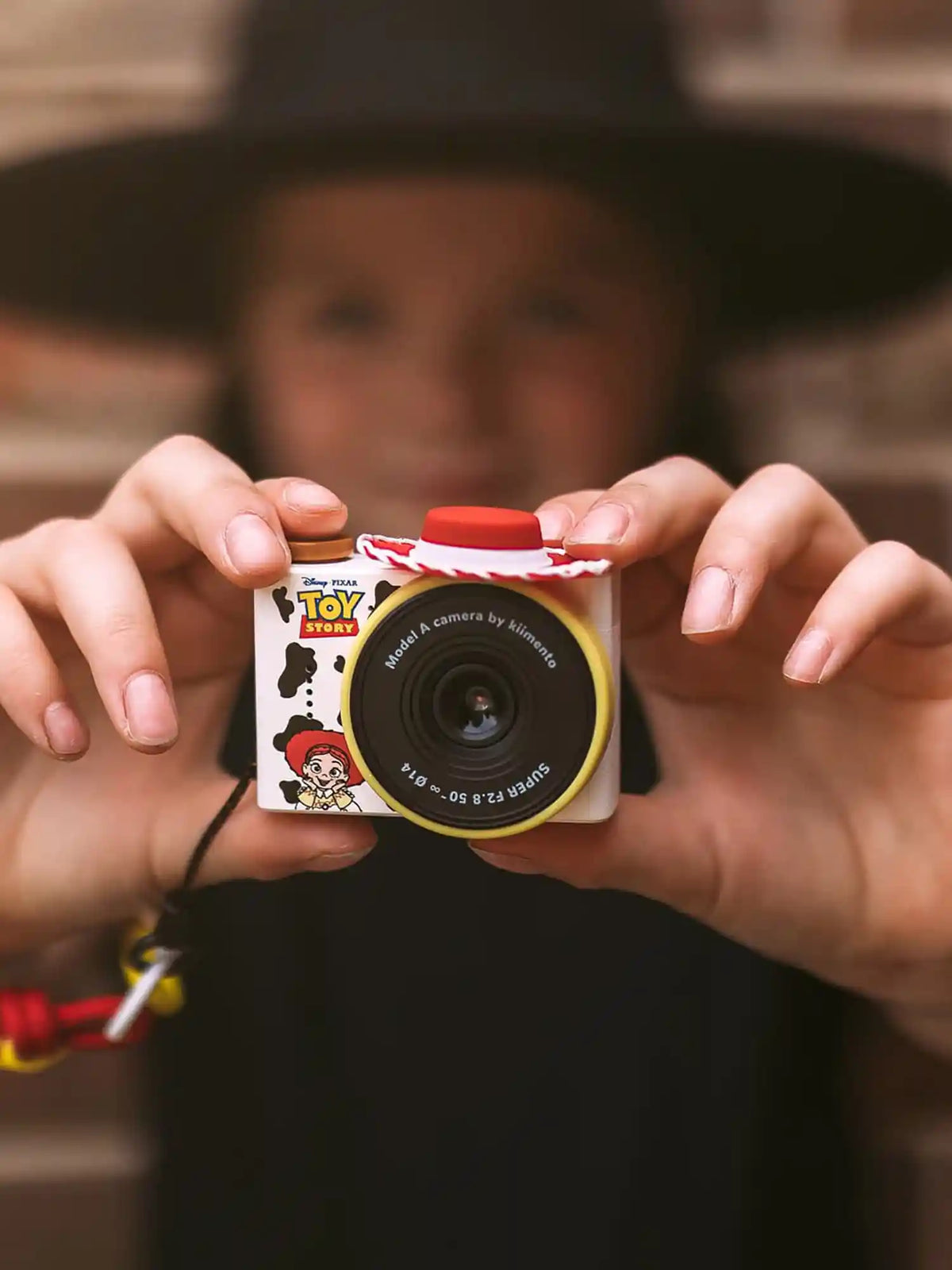 Hands holding kiimento Disney Jessie Mini Camera Model A – Toy Story Jessie cow print mini kids camera