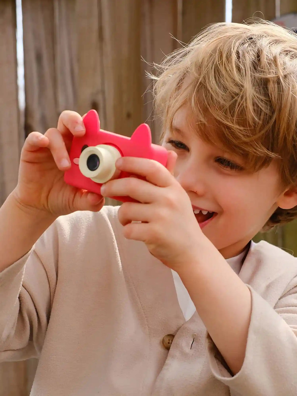 Boy using kiimento Fox Digital Camera Model C outdoors – red fox-shaped kids camera ages 3 to 6