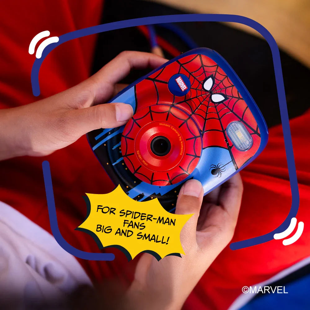 A Spider-Man themed instant print camera held by kid's hands.